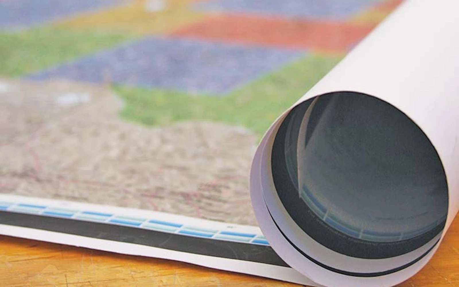 A rolled paper map with the end of its shipping tube in view