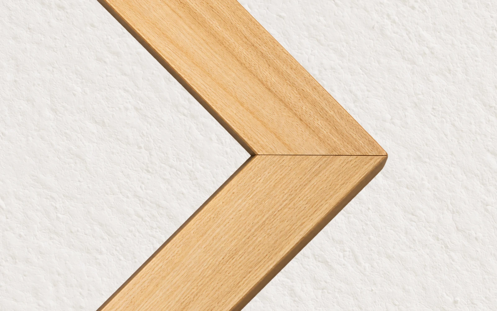 The mitred corner of an unfinished pine picture frame