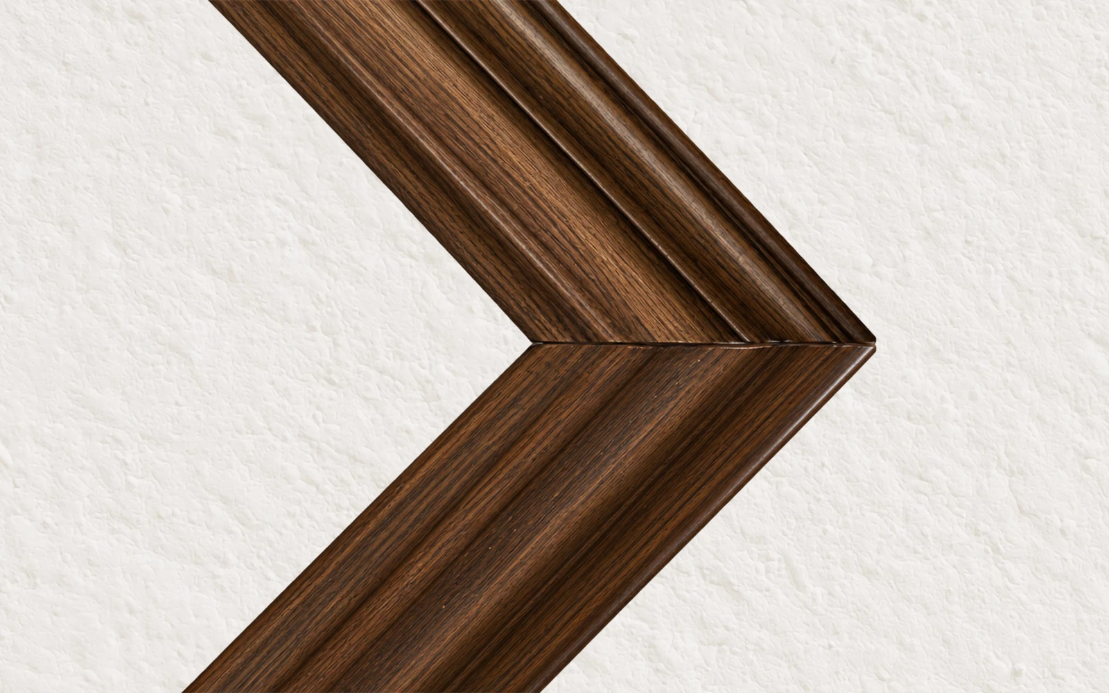 The mitred corner of a dark oak stained wood frame