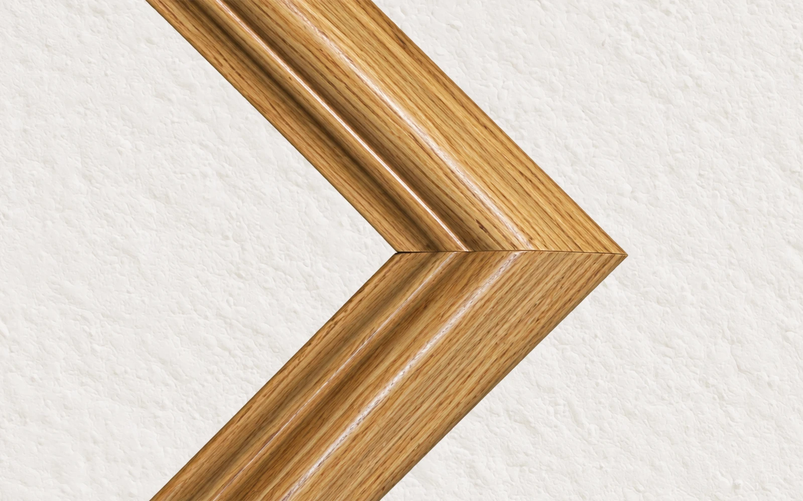 The mitred corner of a light oak stained frame
