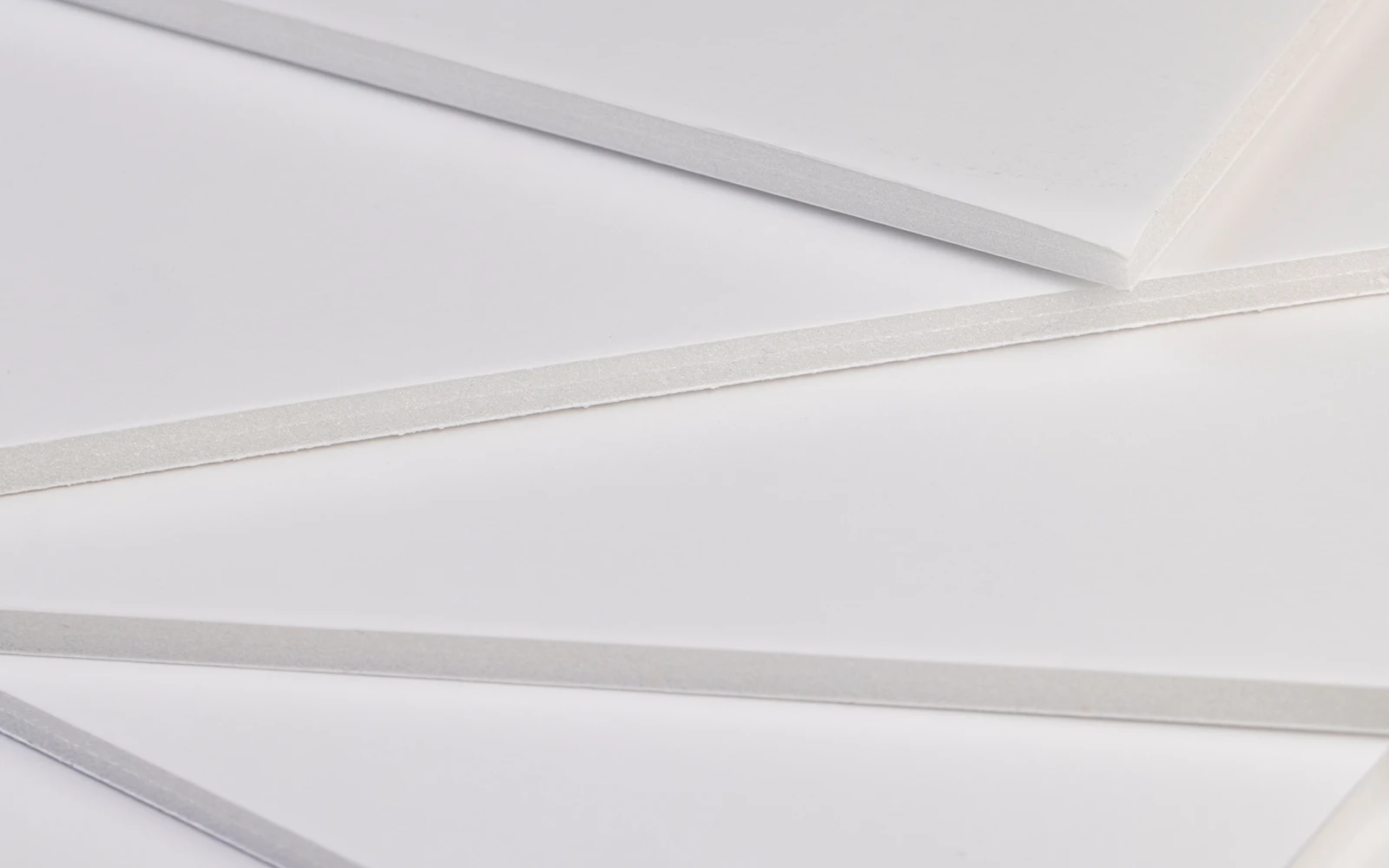 Several white foam board edges fanned to show their thicknesses