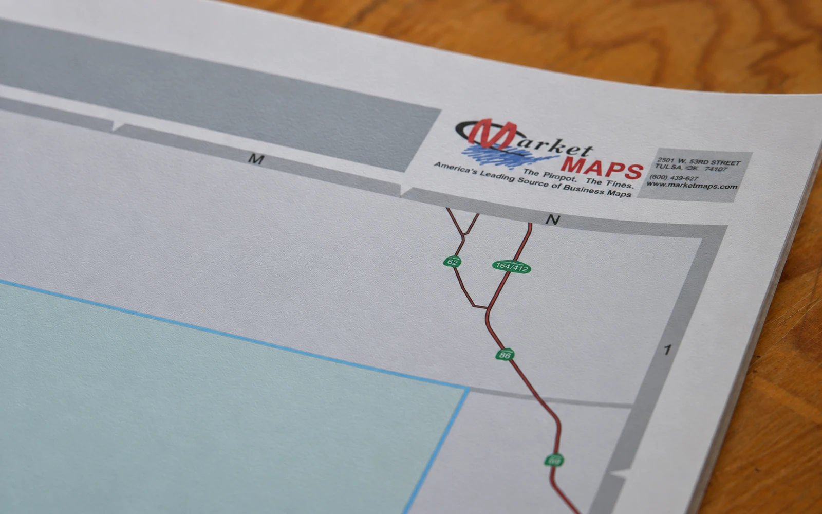 A matte laminated map lying flat on a desk with no glare across its surface
