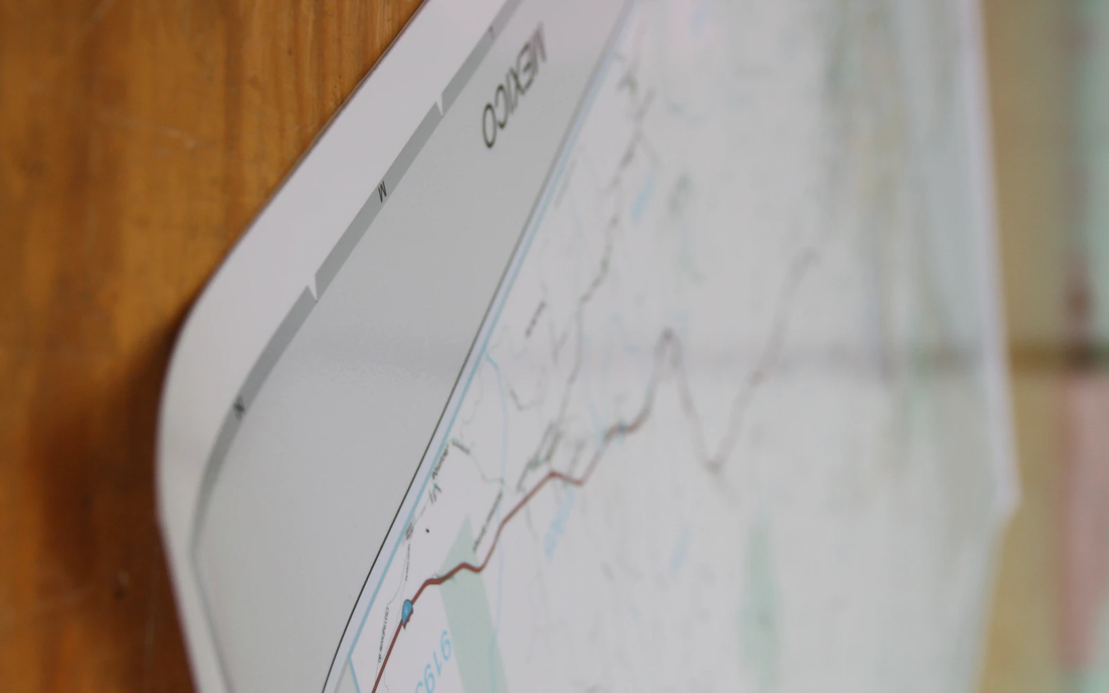 The lifted edge of a matte laminated map, showing its low-sheen surface
