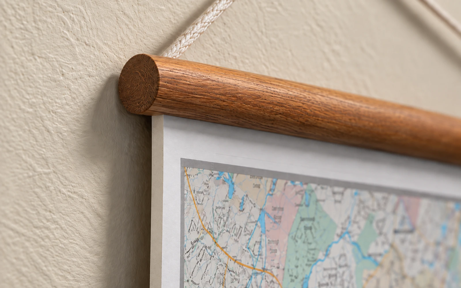 The turned end of the wooden rail where it meets the mounted board