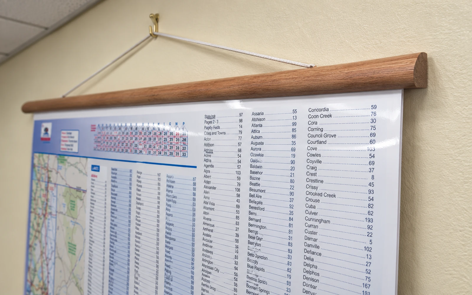 A wall map hung from cherry-stained wooden rails