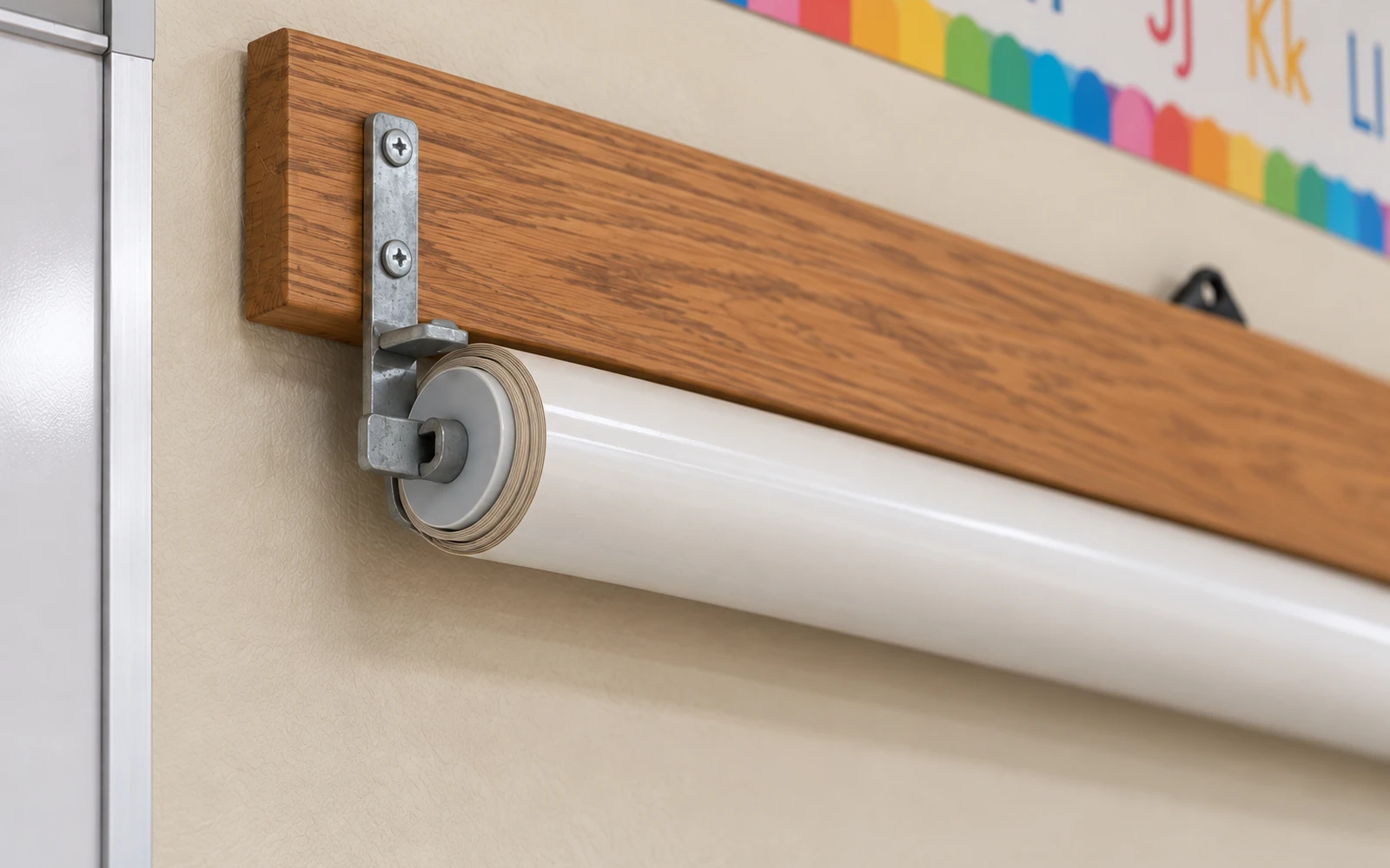 A roller tube mounted to a wooden backboard on a classroom wall