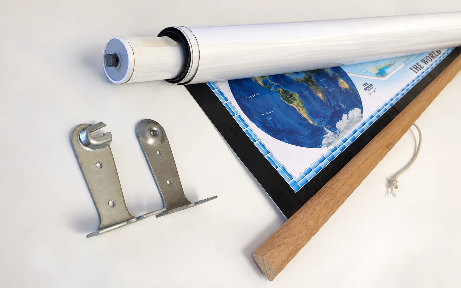 A spring roller, wall brackets and a wooden backboard laid out beside an unrolled map