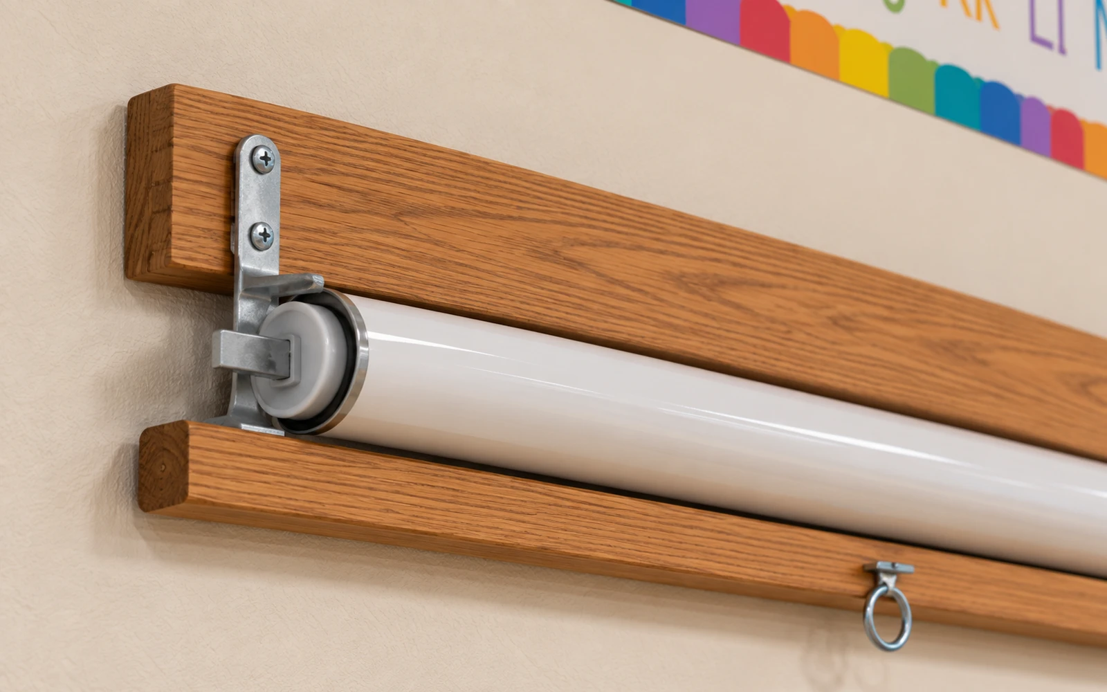 A roller tube mounted to a wooden backboard on a steel bracket