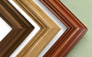 Three ornate hardwood frame corners: dark oak, cherry and light oak