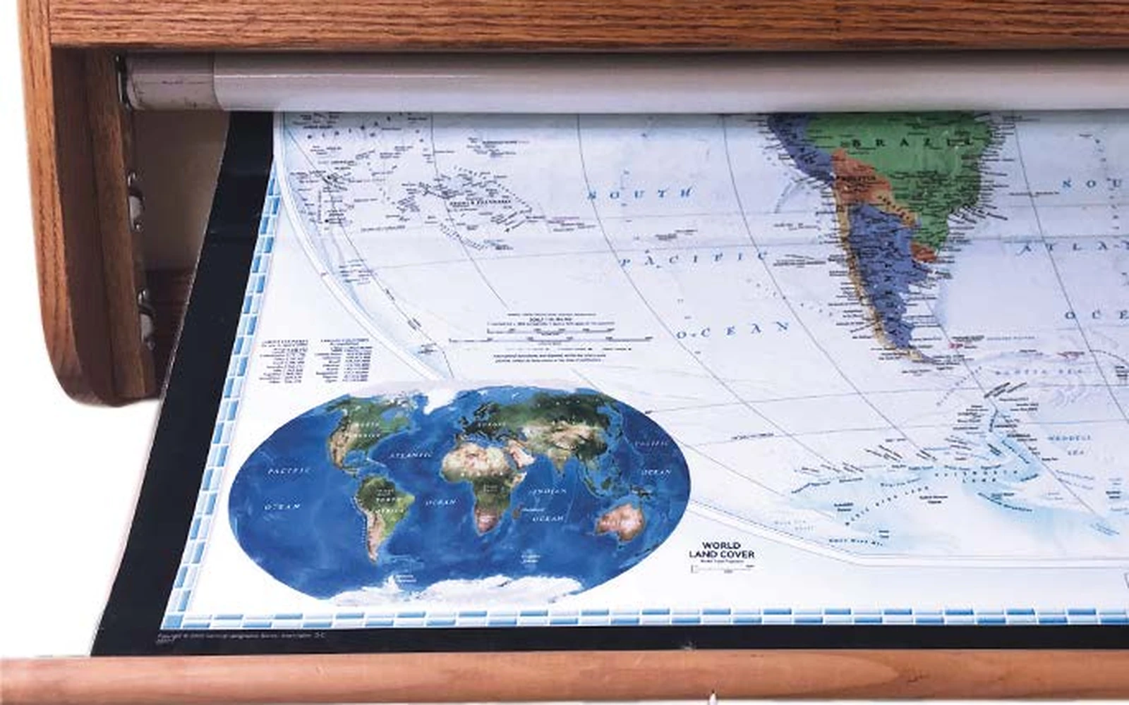 A world map pulled down from under a wooden valance