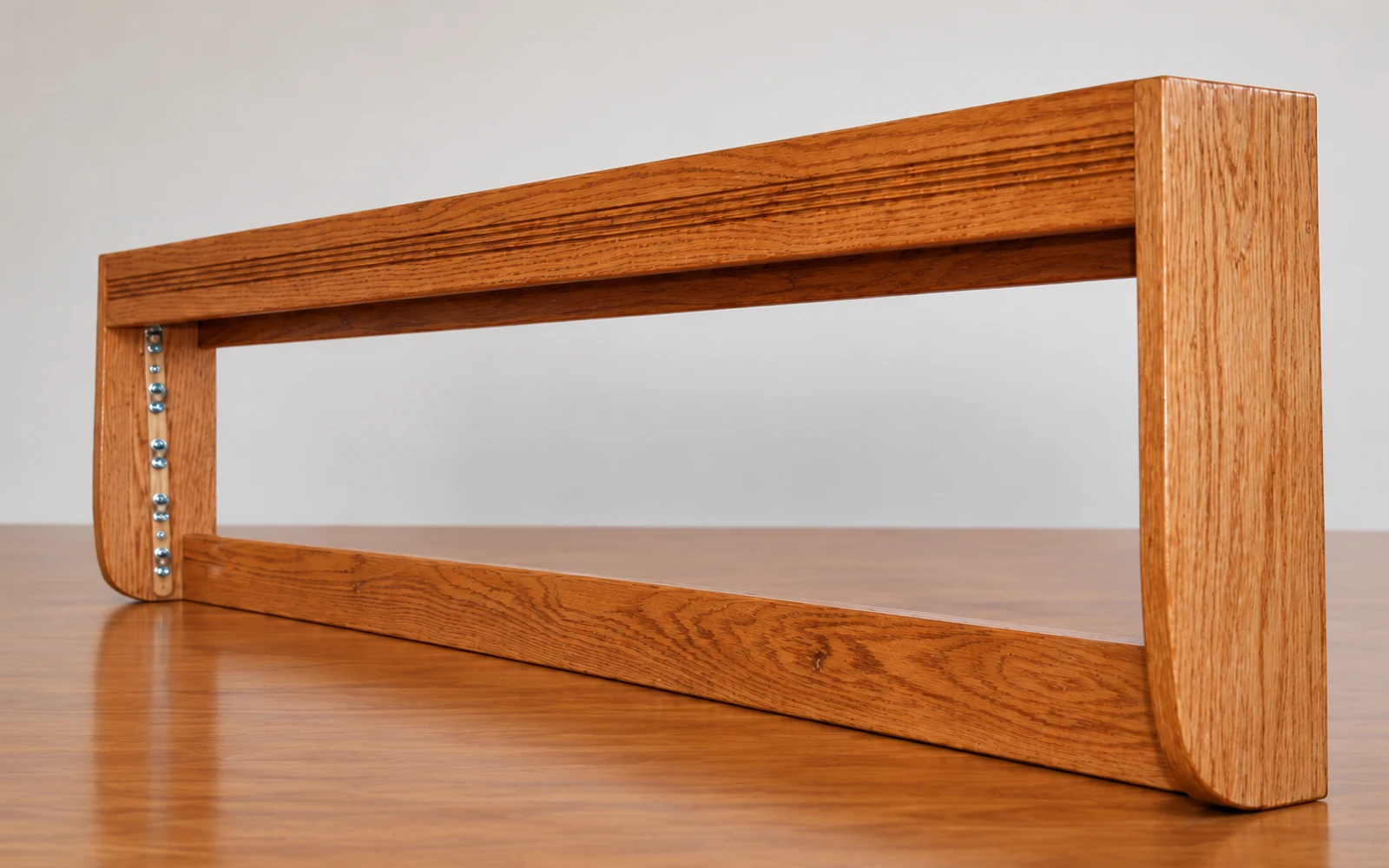 An empty wooden valance housing seen end-on