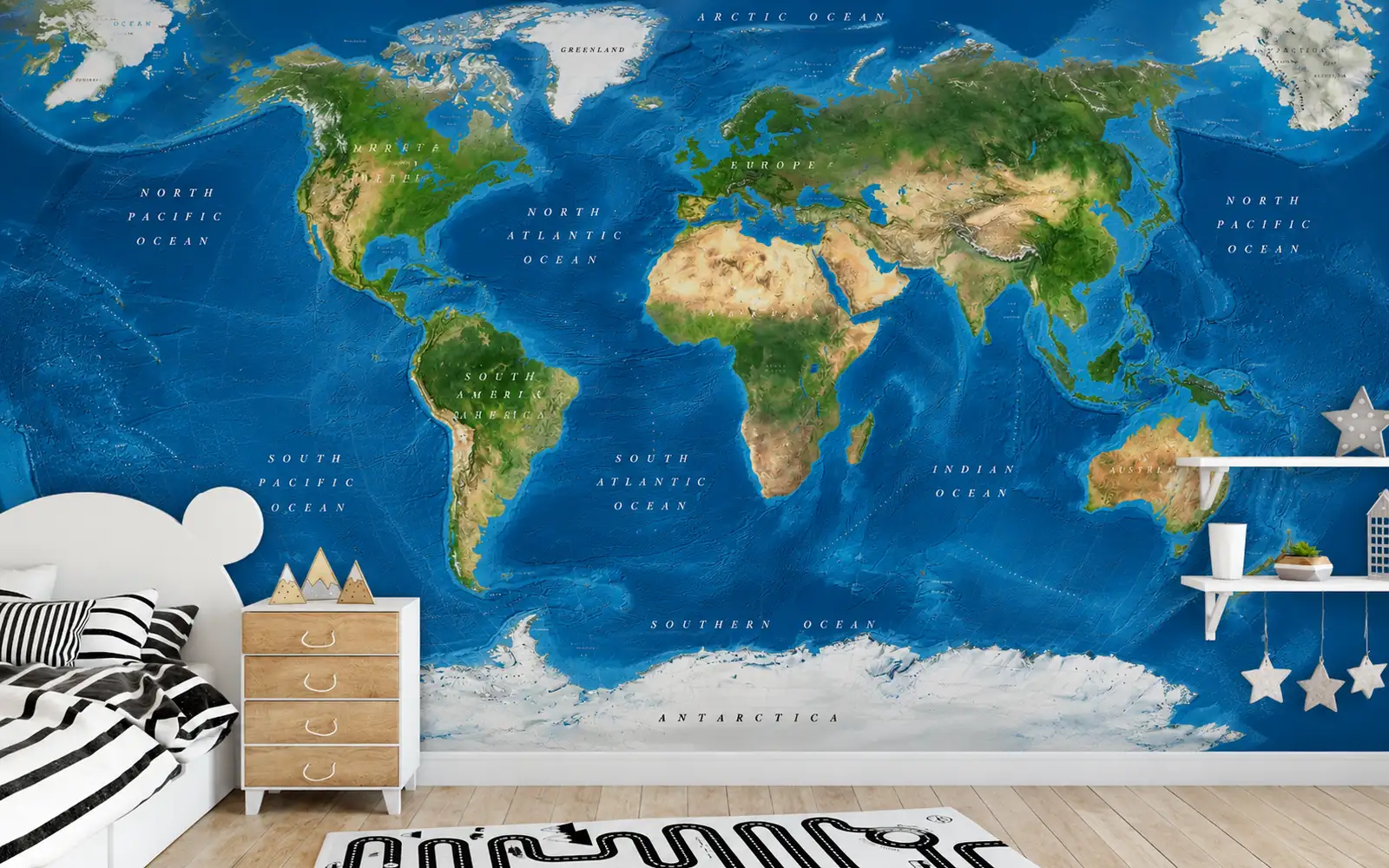A satellite world map covering a child's bedroom wall behind a bed and dresser